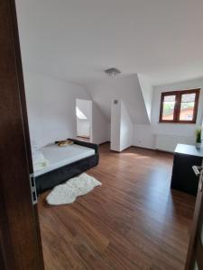 a bedroom with a bed in the middle of a room at Apartment Oliver in Ujazd