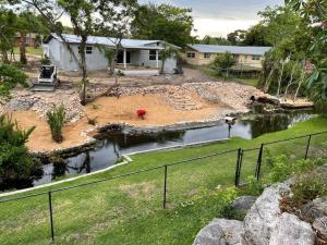a house under construction with a pond in the yard at Vacation home in Melbourne