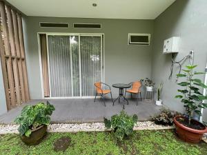 een patio met een tafel, stoelen en planten bij Aryastri Villa in Bandung