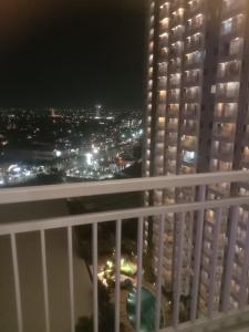 a view of a city at night from a balcony at Elegance in Surabaya