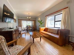 una sala de estar con un sofá y una mesa en Crescent Corner Vacation Home, en Ciudad del Cabo