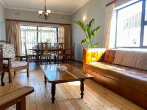 una sala de estar con un sofá y una mesa en Crescent Corner Vacation Home, en Ciudad del Cabo