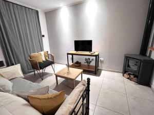 a living room with a couch and a stove at Casa Los Olivos in Nueve de Julio