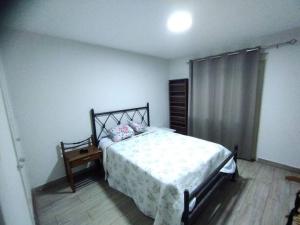 a bedroom with a bed and a wooden floor at Lindo amplio cerca a Larcomar in Lima