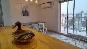 a dining room with a table with a basket on it at TORRE Rivera in Buenos Aires