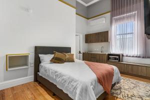 a bedroom with a large bed and a kitchen at Costello Hotels Port Augusta in Port Augusta