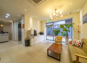 a living room with a couch and a table at Hotel MARE in Busan