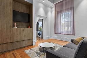 a living room with a couch and a tv at Costello Hotels Port Augusta in Port Augusta