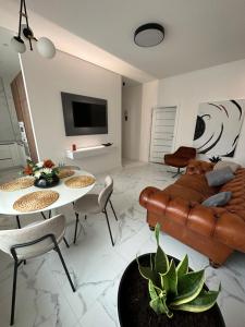 a living room with a couch and a table and chairs at AN apartment 2 in Rēzekne