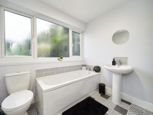 een witte badkamer met een toilet en een wastafel bij House in Solihull - Perfect For Contractors - Working Professionals - Driveway - 9 Mins to BHX Airport - 11 Mins To NEC in Solihull