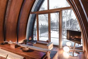 a living room with a large window and a tv at Andaru Collection Niseko in Kutchan +103 photos