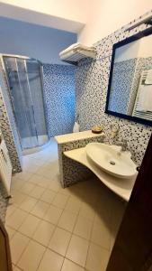 a bathroom with a sink and a mirror at B&B Corte dei Ducati in Comacchio