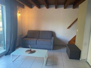 a living room with a couch and a table at Appartement en Provence in Châteaurenard