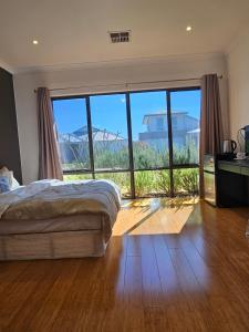 1 dormitorio con cama y ventana grande en Private guest suite, en Perth