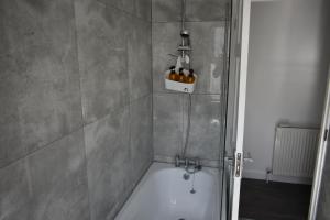 a shower stall with a tub in a bathroom at Seaside Flat, Contractors, Family, Business, Parking in Portslade