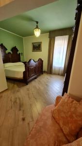a bedroom with two beds and a wooden floor at B&B Corte dei Ducati in Comacchio