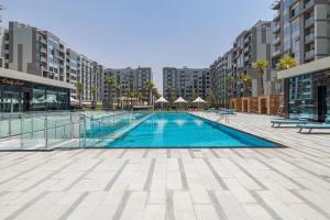 a swimming pool in the middle of a building at Elegant Studio with Pool View and Great Facilities in Dubai