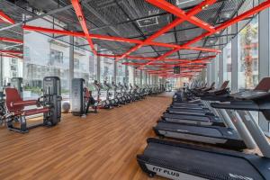a gym with rows of treadmills and machines at Elegant Studio with Pool View and Great Facilities in Dubai