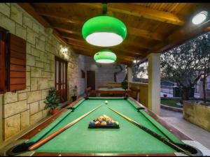 a pool table in the middle of a patio at Charming holiday home with private pool and covered terrace in Škrip
