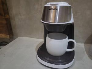Royal Seascape في سان خوان: آلة صنع القهوة مع كوب قهوة أبيض على منضدة