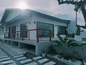 a rendering of a house with the sun behind it at Royal Seascape in San Juan