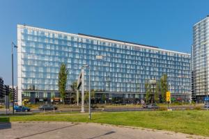 a large office building with a lot of windows at Business Center Apartments Warsaw Wola by Renters in Warsaw