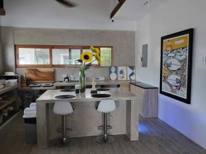 a kitchen with a table with a vase of flowers on it at Royal Seascape in San Juan