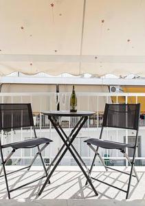 two chairs and a table with a bottle of wine at MEDLUXE EASY ACROPOLIS APARTMENT! in Athens