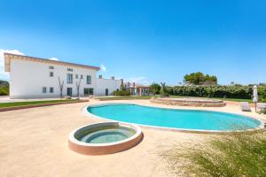 a large swimming pool in front of a building at Masseria Sant'Eleuterio in Collepasso