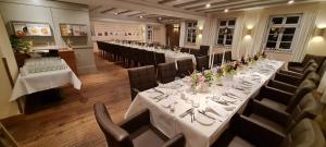 a row of tables and chairs in a restaurant at Restaurant & Hotel Einhorn in Oppenweiler