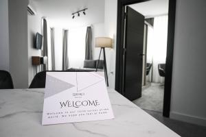 a welcome sign on a table in a hotel room at Hotel LIBERO Delchevo in Delčevo