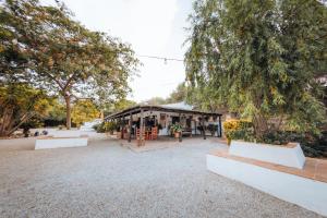 a pavilion with benches in a park with trees at LA CUADRA, Finca a los pies de Sierra Nevada, a 10 minutos del centro, Piscina, Jardín, Barbacoa in La Zubia