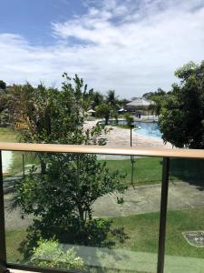 a view of a swimming pool from a balcony at Iloa Flat Barra São Miguel-Alagoas in Barra de São Miguel