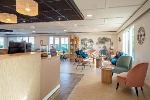an office with a lobby with chairs and tables at Sure Hotel by Best Western Rochefort-sur-Mer in Tonnay-Charente