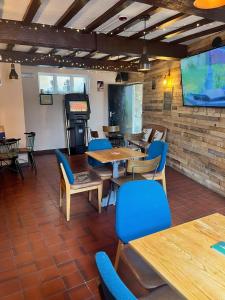 a dining room with tables and chairs and a screen at The Lion Hotel in Llansantffraid-ym-Mechain +17 photos