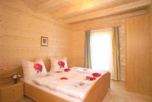 a bedroom with a bed with roses on it at Jagdhaus Wagrain in Wagrain
