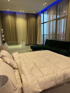 una camera con un grande letto e un divano di شاليهات الاطلالة a Al Khobar