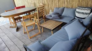 a couch and a table and a table and chairs at Pokoje Gościnne in Lębork
