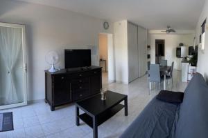 a living room with a couch and a table at calme et paisible in La Ciotat