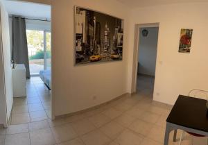 a living room with a picture on the wall at calme et paisible in La Ciotat +8 photos