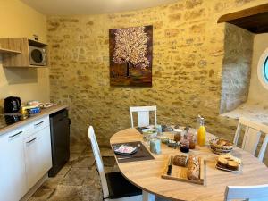 - une cuisine avec une table en bois et de la nourriture dans l'établissement Chambres Vaugoubert, à Saint-Germain-de-Varreville