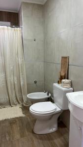 a bathroom with a toilet and a sink at Departamento complejo Vita in Concepción del Uruguay