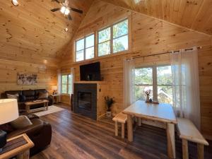 a living room with a table and a fireplace at Fully Loaded Cabin In Heart Of Pigeon Forge in Pigeon Forge