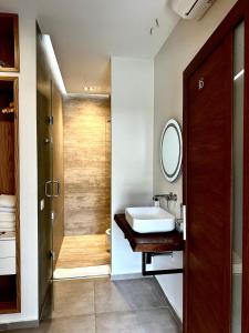 a bathroom with a sink and a mirror at Luna Mare Seaside Suites in Borsh