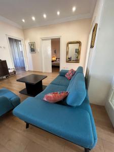 a blue couch in a living room with a mirror at Terazije Square Lux Apartment in Belgrade