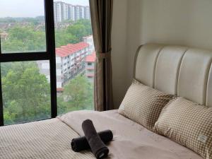a bed with a stuffed animal on it with a window at A0803 Platino walking ParadigmMall TVbox By STAY in Johor Bahru +37 photos