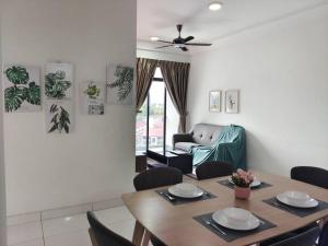 a dining room with a table and a couch at A0803 Platino walking ParadigmMall TVbox By STAY in Johor Bahru