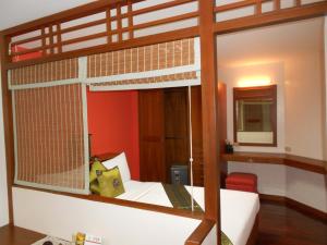 a bedroom with a wooden bunk bed with a mirror at B.S. Court Hotel Sathorn in Bangkok +45 photos