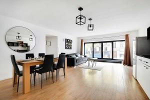 a dining room and living room with a table and chairs at Superb apartment in the heart of the 2nd arrond of Paris 8P3B in Paris
