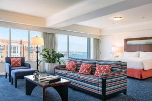 a hotel room with a bed and a couch at Renaissance Boston Waterfront Hotel in Boston